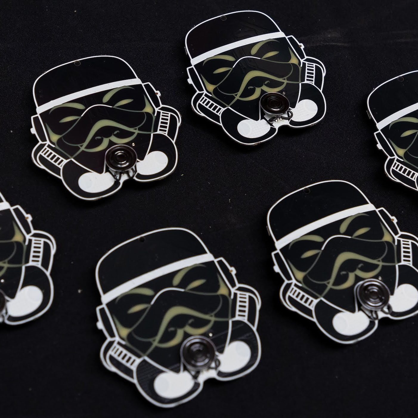 THOTCON 0xA badges (2019): helmet-shaped black boards